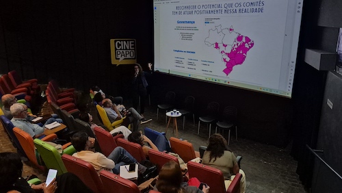 Debates sobre segurança hídrica e governança da água marca encontro de comitês de bacias na Bahia Reunião reuniu representantes de 14 colegiados e discutiu impactos de mudanças regulatórias e desafios climáticos na gestão dos recursos hídricos A gestão dos recursos hídricos e os desafios crescentes relacionados à segurança da água na Bahia e no Brasil estiveram no centro da 30ª Reunião Plenária Ordinária do Fórum Baiano de Comitês de Bacias Hidrográficas (FBCBH), realizada nos dias 8 e 9 de abril, em Salvador. O encontro reuniu representantes dos 14 comitês de bacias do estado, além de especialistas e gestores públicos da Agência Nacional de Águas (ANA), Agência Pernambucana de Água e Clima (APAC), Fórum Fluminense de Comites de Bacias Hidrográficas (RJ), Secretarias de Meio Ambiente da Bahia e Sergipe, entre outras, em torno de temas como governança, equidade de gênero, eventos extremos e mudanças no marco regulatório do setor. O debate ocorre em um contexto de maior pressão sobre os recursos hídricos, impulsionado por eventos climáticos mais intensos, como secas prolongadas e chuvas extremas, e pela necessidade de aprimorar os instrumentos de gestão da água nas bacias do estado. Nesse cenário, os comitês de bacias — instâncias que reúnem poder público, usuários e sociedade civil — têm papel estratégico na mediação de conflitos e na definição de prioridades para o uso da água. Na Bahia, os comitês atuam em diferentes regiões hidrográficas, com desafios que vão desde a escassez hídrica até a pressão sobre mananciais urbanos. A reunião do Fórum buscou alinhar estratégias e ampliar o debate sobre a atuação desses colegiados diante de um cenário de maior complexidade. “A atuação dos comitês de bacias se torna ainda mais estratégica diante de um contexto de maior variabilidade climática e de pressões sobre os recursos hídricos. Fortalecer esses espaços é fundamental para garantir decisões mais equilibradas e sustentáveis”, afirma Ana Odália Sena, coordenadora do Fórum Baiano de Comitês de Bacias Hidrográficas. Entre os principais pontos discutidos esteve o Projeto de Lei 4.546/2021, que propõe mudanças na governança dos recursos hídricos no país. O tema mobilizou representantes do setor público e dos comitês, com foco na avaliação de seus impactos para o modelo de gestão participativa. “A proposta traz implicações relevantes para a governança dos recursos hídricos e para a forma como os comitês participam das decisões. É fundamental ampliar o diálogo para avaliar os possíveis impactos e garantir a manutenção dos avanços já consolidados”, observa Larissa Cayres, coordenadora de recursos hídricos da Secretaria do Meio Ambiente da Bahia. A agenda também destacou a segurança hídrica como um dos principais desafios atuais. O conceito envolve não apenas o acesso à água em quantidade e qualidade adequadas, mas também a capacidade de resposta a eventos extremos. “A segurança hídrica deixou de ser uma agenda setorial e passou a ser um tema estruturante para o desenvolvimento. Os comitês de bacias têm papel fundamental na articulação entre diferentes interesses e na construção de soluções adaptadas às realidades locais”, avalia Luiz Henrique Pinheiro, especialista em Regulação de Recursos Hídricos da Agência Nacional de Águas e Saneamento Básico (ANA). Luiz Henrique ainda afirmou que o tema segurança hídrica já faz parte do Plano de Recursos Hídricos de diversos Comitês de Bacia Hidrográfica do país. Do ponto de vista territorial, os desafios enfrentados pelos comitês também foram destacados durante o encontro. “A gestão da água exige conciliar diferentes usos e lidar com situações cada vez mais complexas, como a desertificação, os períodos de escassez e eventos extremos. Os comitês são espaços fundamentais para construir soluções coletivas”, comenta Paulo Neiva, presidente do Comitê da Bacia Hidrográfica dos Rios Verde e Jacaré. Ao final da reunião, os membros do FBCBH aprovaram o convite aos deputados federais baianos Alice Portugal e Pastor Sargento Isidório (que fazem parte da comissão de discussão da PL) para discussão sobre a PL 4546/2021 e a junção e divulgação dos dados da PL para divulgação à sociedade, a solicitação de revisão dos Regimentos Internos dos Comitês para inclusão da equidade de gênero nas diretorias e a criação, proposta pelo FBCBH, de oficinas de capacitação pelos Comitês para reestruturação de seus planejamentos estratégicos e do próprio FBCBH, reforçando o papel dos comitês de bacias como instâncias centrais para o fortalecimento do Sistema de Gerenciamento de Recursos Hídricos e para a construção de respostas frente aos desafios hídricos no estado e no país.