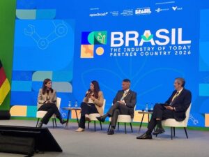 A crescente relevância dos minerais críticos na economia global marcou a participação do Instituto Brasileiro de Mineração (IBRAM) na Hannover Messe, maior feira de tecnologia industrial do mundo. Realizada entre os dias 19 e 22 de abril de 2026, na cidade de Hannover, na Alemanha, o encontro contou com a participação da gerente de Assuntos Minerários do instituto, Aline Nunes. Ela detalhou a estruturação do setor mineral brasileiro para liderar esta pauta estratégica global, fundamentada no cenário da riqueza geológica do Brasil combinada com uma matriz elétrica na qual mais de 90% da energia advém de fontes renováveis. A agenda de participação na Hannover Messe no dia 21 de abril integrou um missão oficial brasileira no país, organizada pelo Governo Alemão, realizada entre 19 e 25 de abril de 2026. No mesmo dia, Aline participou como painelista do encontro “Transição Energética e Minerais Críticos”, realizado no Pavilhão Brasil da feira. O debate reuniu especialistas do setor e destacou o papel estratégico da mineração na descarbonização e no avanço de novas tecnologias. A participação do IBRAM reforçou a presença institucional do Brasil em um evento que teve o país como parceiro oficial nesta edição.